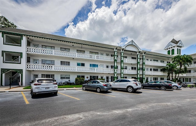 view of building exterior with uncovered parking