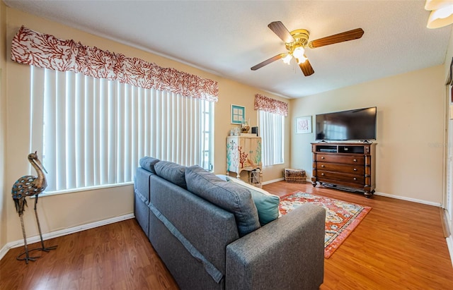 living room featuring hardwood / wood-style flooring and ceiling fan