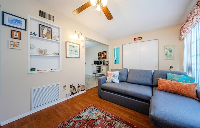 living room with hardwood / wood-style flooring and ceiling fan