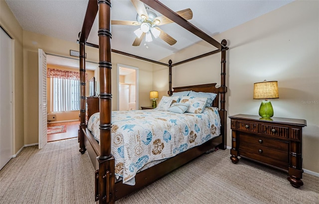 bedroom featuring ceiling fan and light carpet