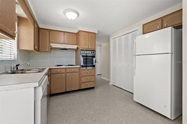 kitchen with decorative backsplash, sink, and stainless steel appliances