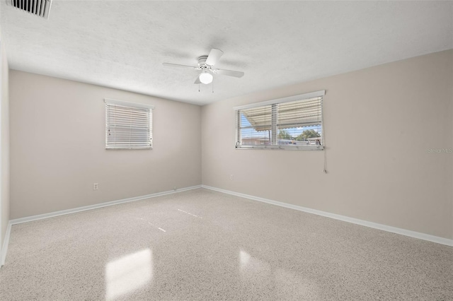 spare room featuring a textured ceiling and ceiling fan