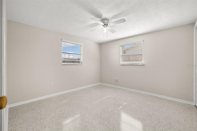 empty room with a textured ceiling and ceiling fan