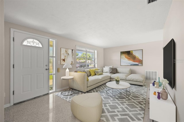 living room with a textured ceiling