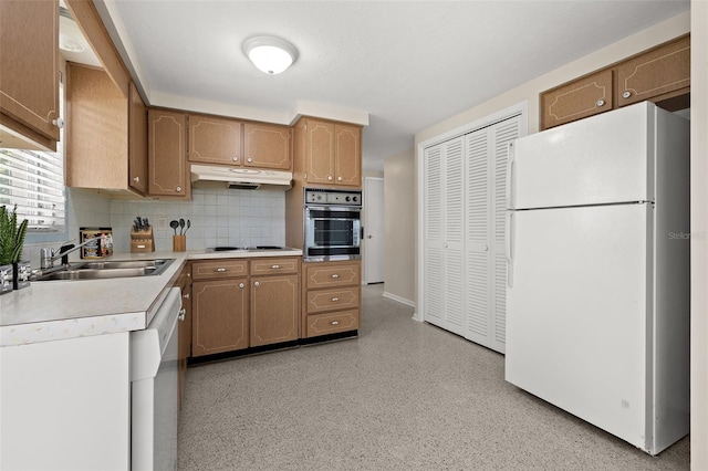 kitchen with sink, stainless steel appliances, and backsplash