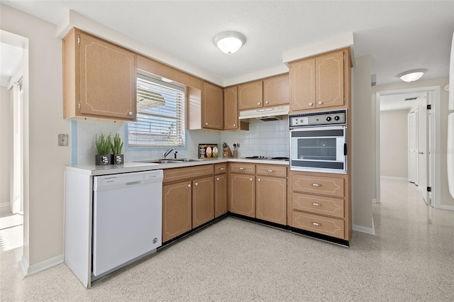 kitchen featuring stainless steel appliances, backsplash, light brown cabinets, and sink