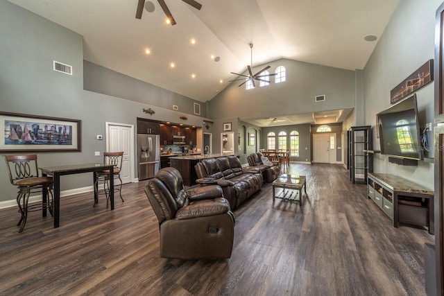 living room with dark hardwood / wood-style flooring, high vaulted ceiling, and ceiling fan