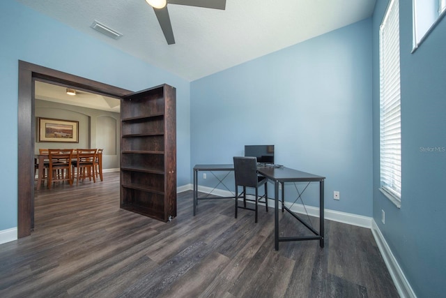 home office with dark hardwood / wood-style flooring and ceiling fan