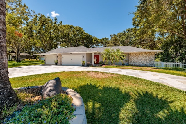 ranch-style home with a garage and a front yard