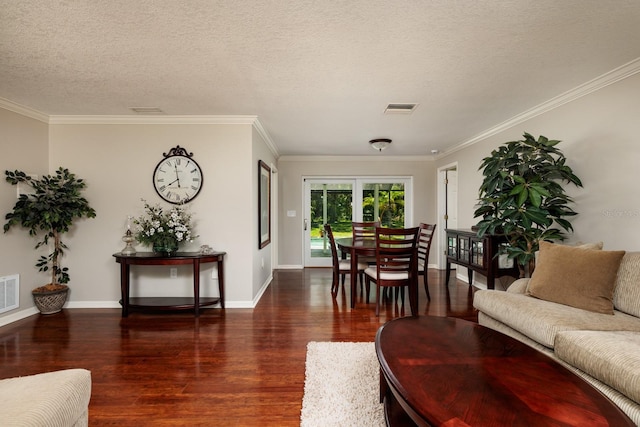 living room featuring dark hardwood / wood-style floors, crown molding, and a textured ceiling