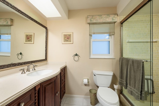 bathroom featuring tile patterned flooring, vanity, a shower with door, and toilet