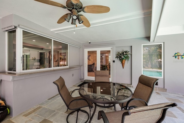 sunroom / solarium featuring beamed ceiling and ceiling fan