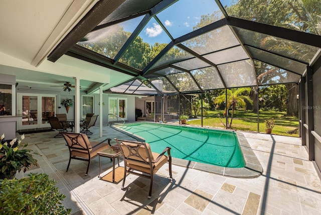 view of swimming pool with french doors, glass enclosure, ceiling fan, and a patio area