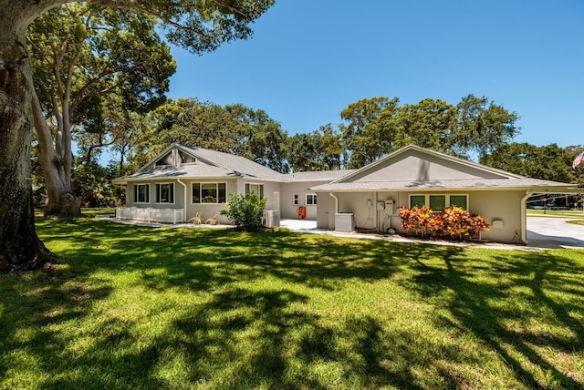 ranch-style house with central AC and a front lawn