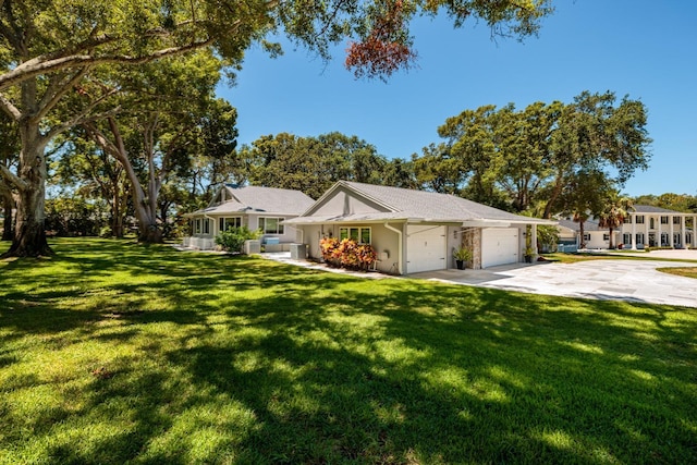 ranch-style house featuring a front lawn and a garage