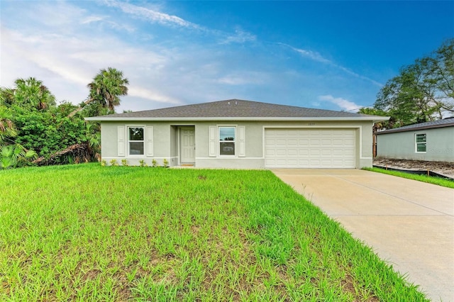 ranch-style house featuring a garage and a front lawn