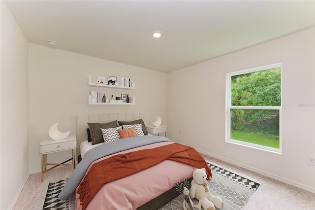 bedroom with multiple windows and carpet floors