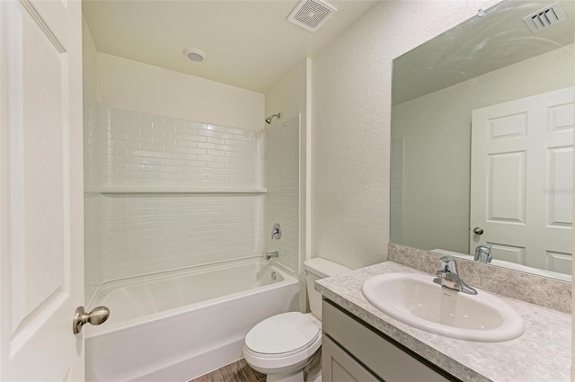 full bathroom featuring hardwood / wood-style flooring, vanity, bathtub / shower combination, and toilet