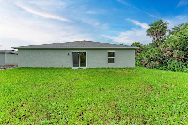 back of house with a lawn