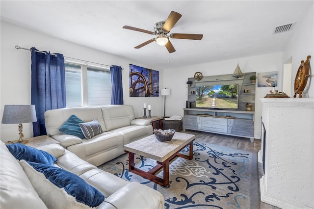 living room with hardwood / wood-style flooring and ceiling fan