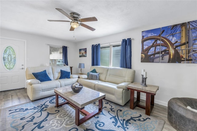 living room featuring ceiling fan and light wood-type flooring