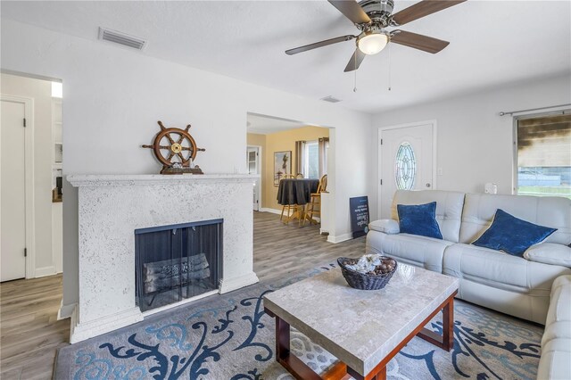 living room featuring hardwood / wood-style flooring and ceiling fan