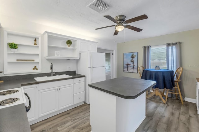 kitchen featuring white refrigerator, sink, light hardwood / wood-style flooring, and white cabinets