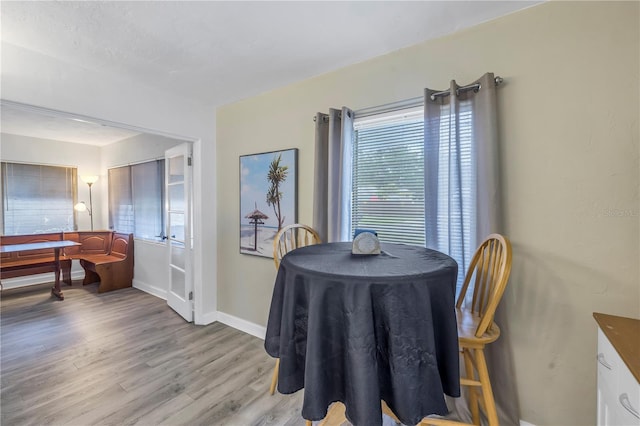 dining space featuring plenty of natural light and light hardwood / wood-style floors