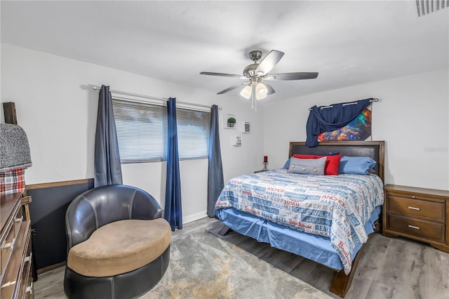 bedroom with light hardwood / wood-style flooring and ceiling fan