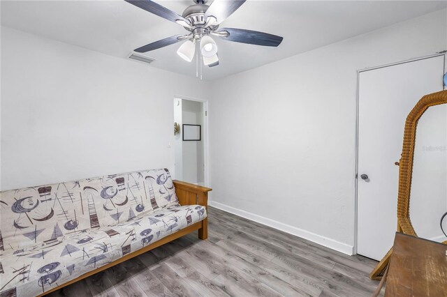 living area featuring ceiling fan and wood-type flooring