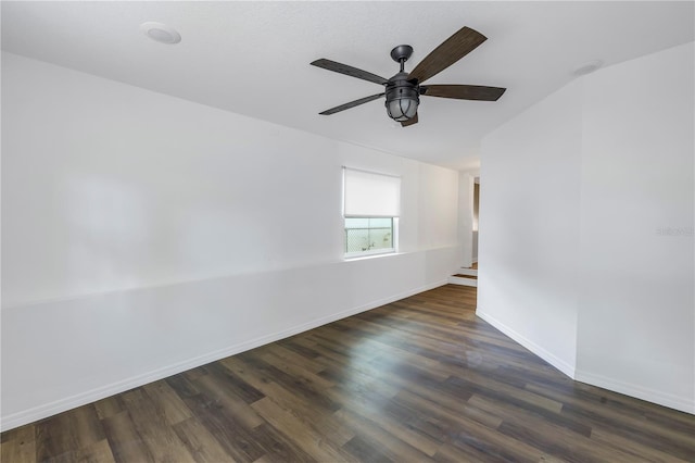 empty room featuring dark hardwood / wood-style flooring and ceiling fan