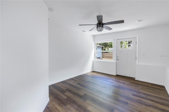 empty room featuring ceiling fan and dark hardwood / wood-style flooring