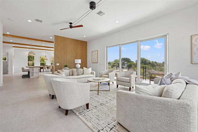 living room featuring beam ceiling and ceiling fan