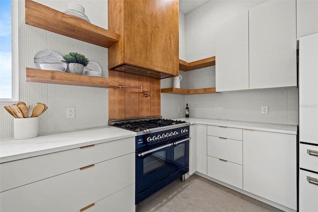 kitchen with gas stove, tasteful backsplash, and white cabinets