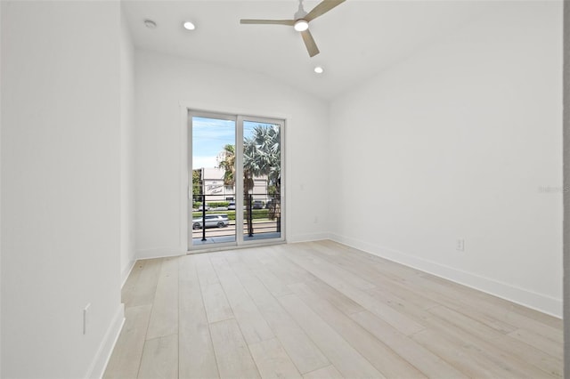 spare room featuring ceiling fan, lofted ceiling, and light hardwood / wood-style flooring