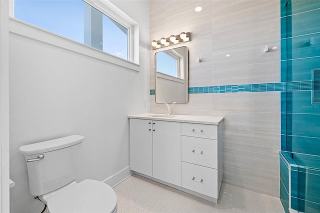 bathroom with tile patterned flooring, vanity, and toilet