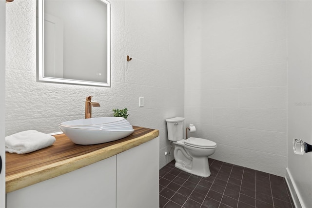 bathroom with tile patterned flooring, vanity, and toilet