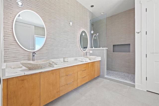 bathroom featuring vanity, tile walls, and tiled shower