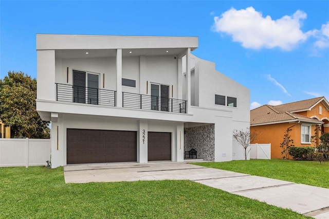 modern home with a balcony, a garage, and a front lawn