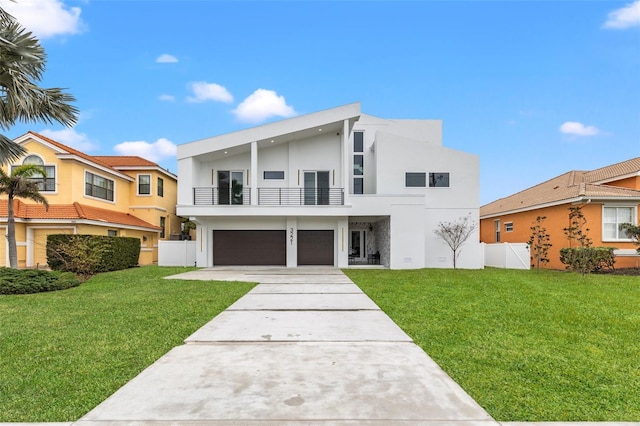 modern home featuring a garage, a balcony, and a front yard