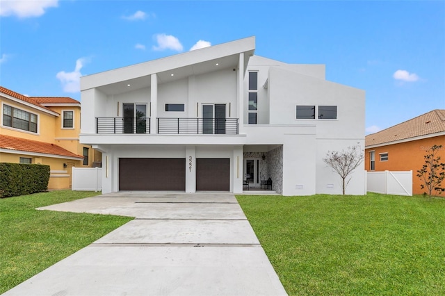 modern home with a front yard, a balcony, and a garage