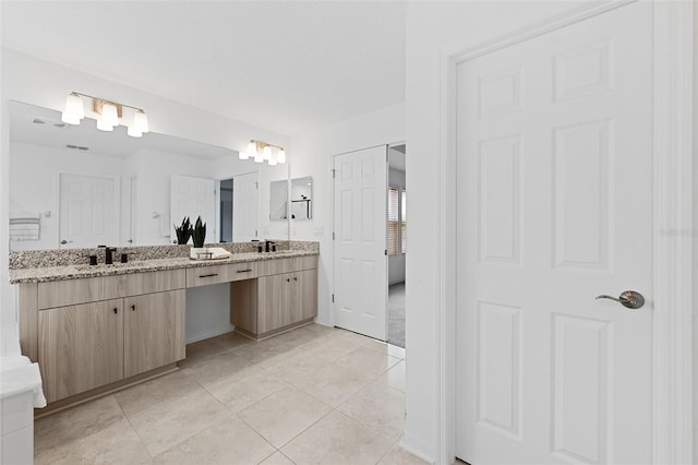 bathroom with tile patterned floors and vanity