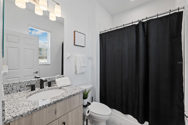 bathroom featuring walk in shower, vanity, and toilet