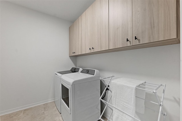 laundry room featuring cabinets and separate washer and dryer