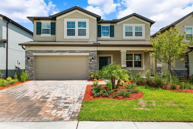 craftsman house featuring a garage and a front yard