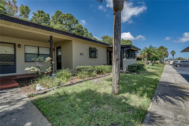 view of side of property with a yard