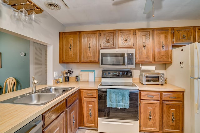 kitchen with ceiling fan, appliances with stainless steel finishes, and sink