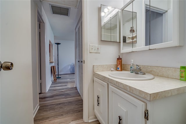 bathroom featuring vanity and wood-type flooring