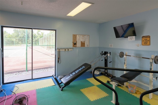 workout room with a textured ceiling