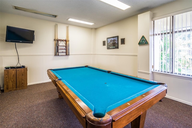 playroom with dark colored carpet, a textured ceiling, and billiards